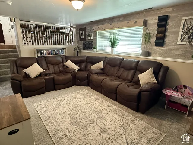 Wood-plank accent wall featuring a custom window valance, built-in shelving unit, and white spindle railing