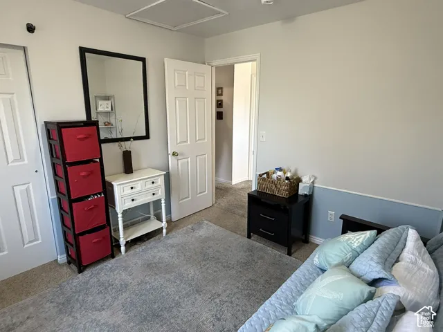 Neutral-toned interior featuring multi-panel interior doors, wall-to-wall carpeting, and two-tone wall detailing with chair rail trim