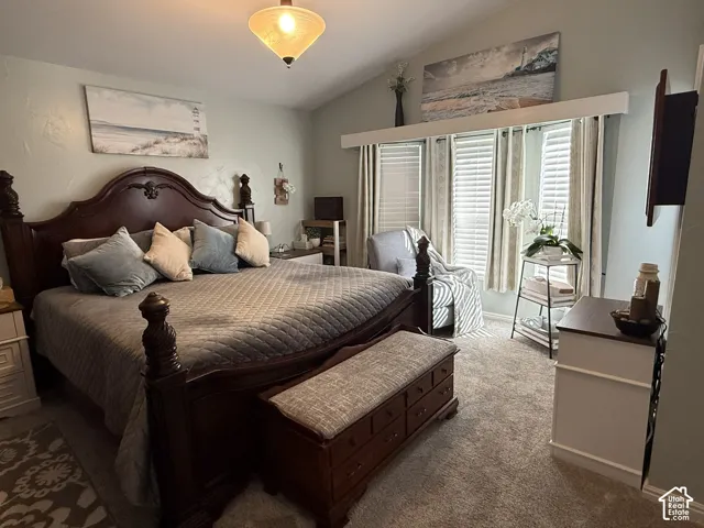 Vaulted ceilings featuring a central pendant light fixture and a multi-pane bay window assembly with integrated horizontal blinds