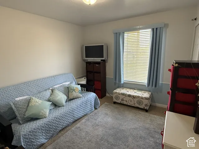 Neutral-toned interior featuring horizontal window blinds, chair rail molding, and a flush-mount ceiling light fixture