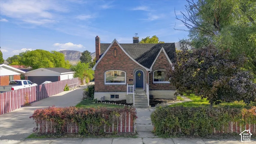 Brick exterior featuring a steeply pitched roofline, arched entryway.
