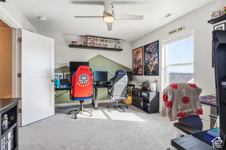 Second bedroom. Neutral-toned interior space featuring carpeting, a ceiling-mounted light fixture with fan