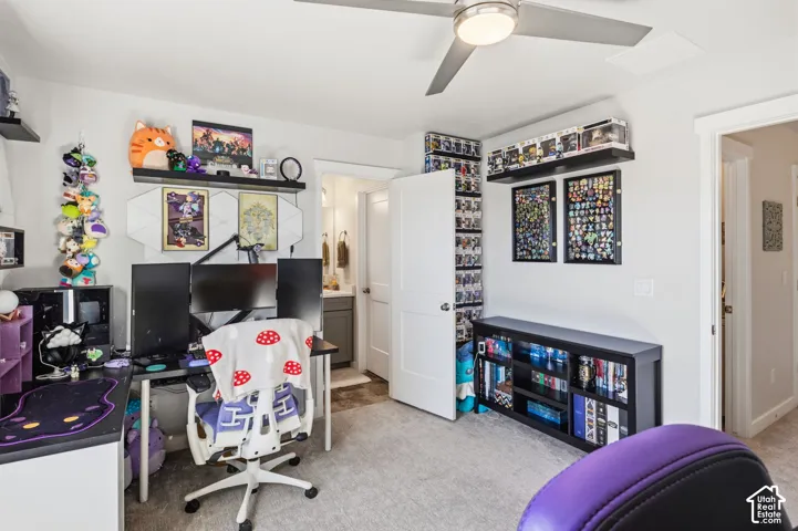 Second bedroom. Neutral-toned room featuring wall-to-wall carpeting, a ceiling fan with integrated lighting, and access to bathroom