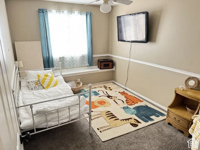 Interior space featuring neutral-tone walls, chair rail molding, a wall-mounted ledge, and carpeted flooring