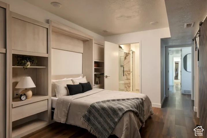 Custom light-wood built-in cabinetry featuring integrated shelving, recessed ceiling lighting, wood-finish flooring, and solid-core doors