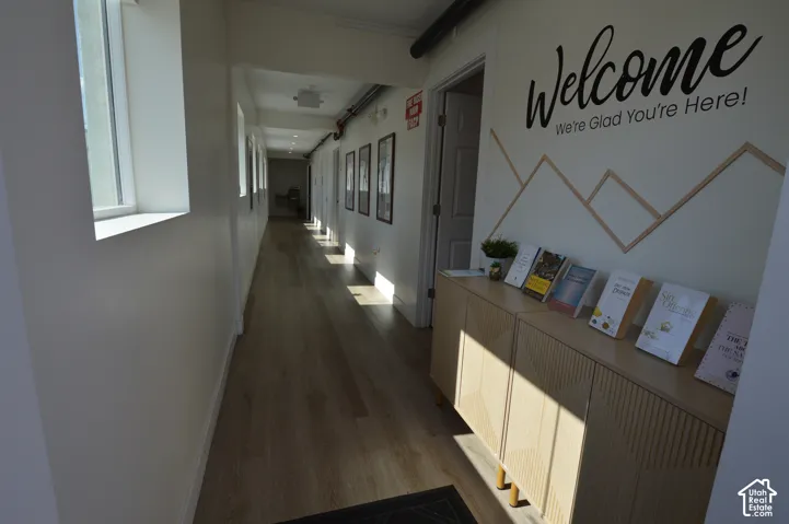 Hallway featuring wood-finish flooring and recessed lighting.