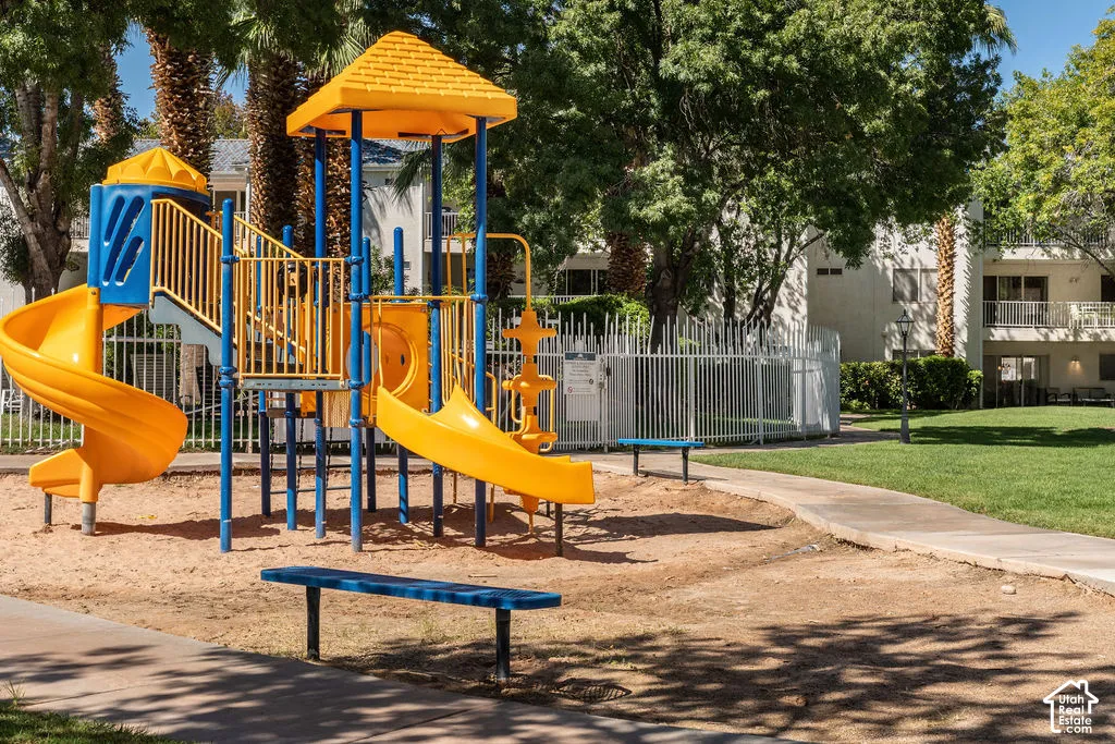 Playground structure featuring multiple slides and climbing elements