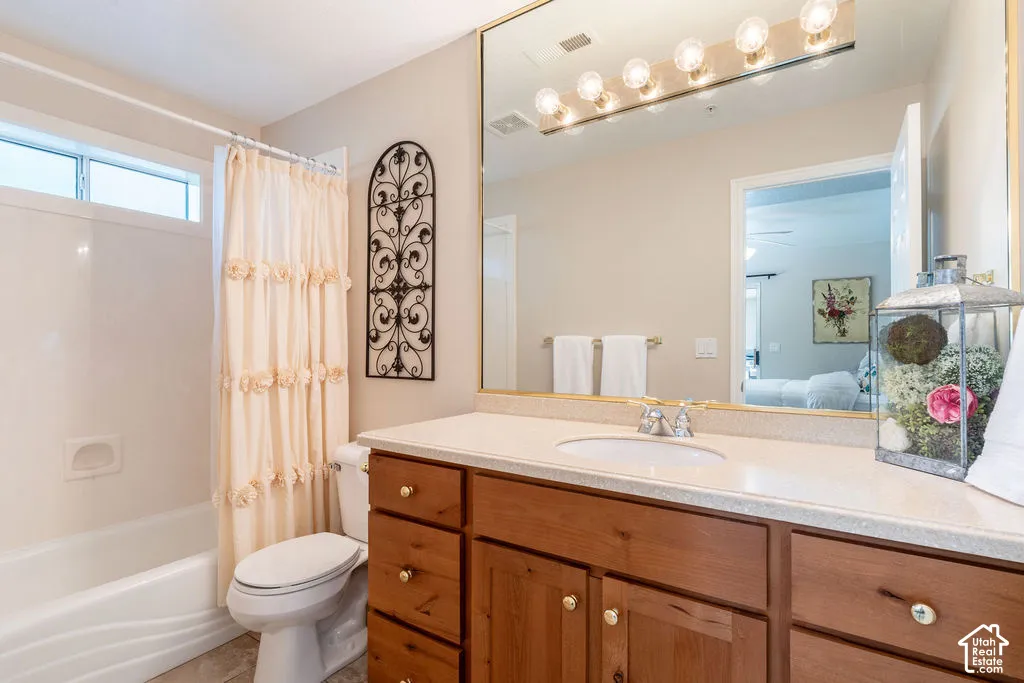 Wood-finish vanity with a light-colored countertop, integrated sink, and chrome faucet