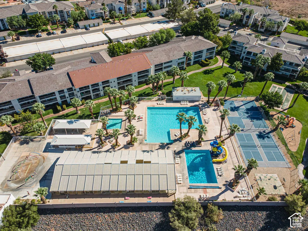 Community features multiple swimming pools, sports courts, and shaded outdoor areas