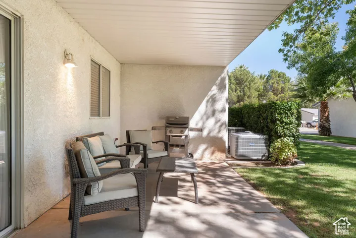 Covered patio featuring a concrete slab and stucco exterior