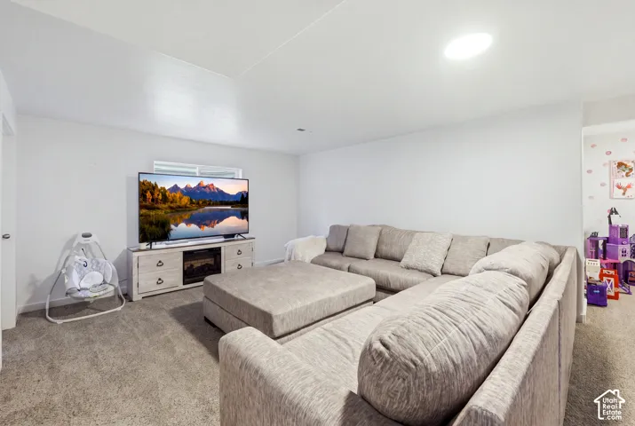 Neutral-toned wall-to-wall carpeting and recessed ceiling lighting