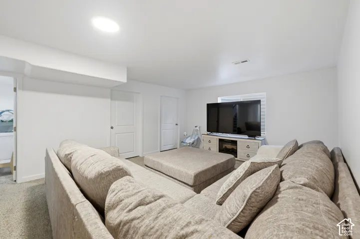Neutral-toned carpeting, recessed ceiling lighting, and solid-core interior doors