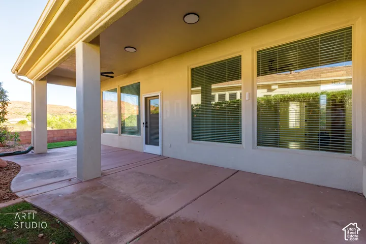Covered patio featuring concrete flooring, recessed lighting, and large windows set against a desert landscape