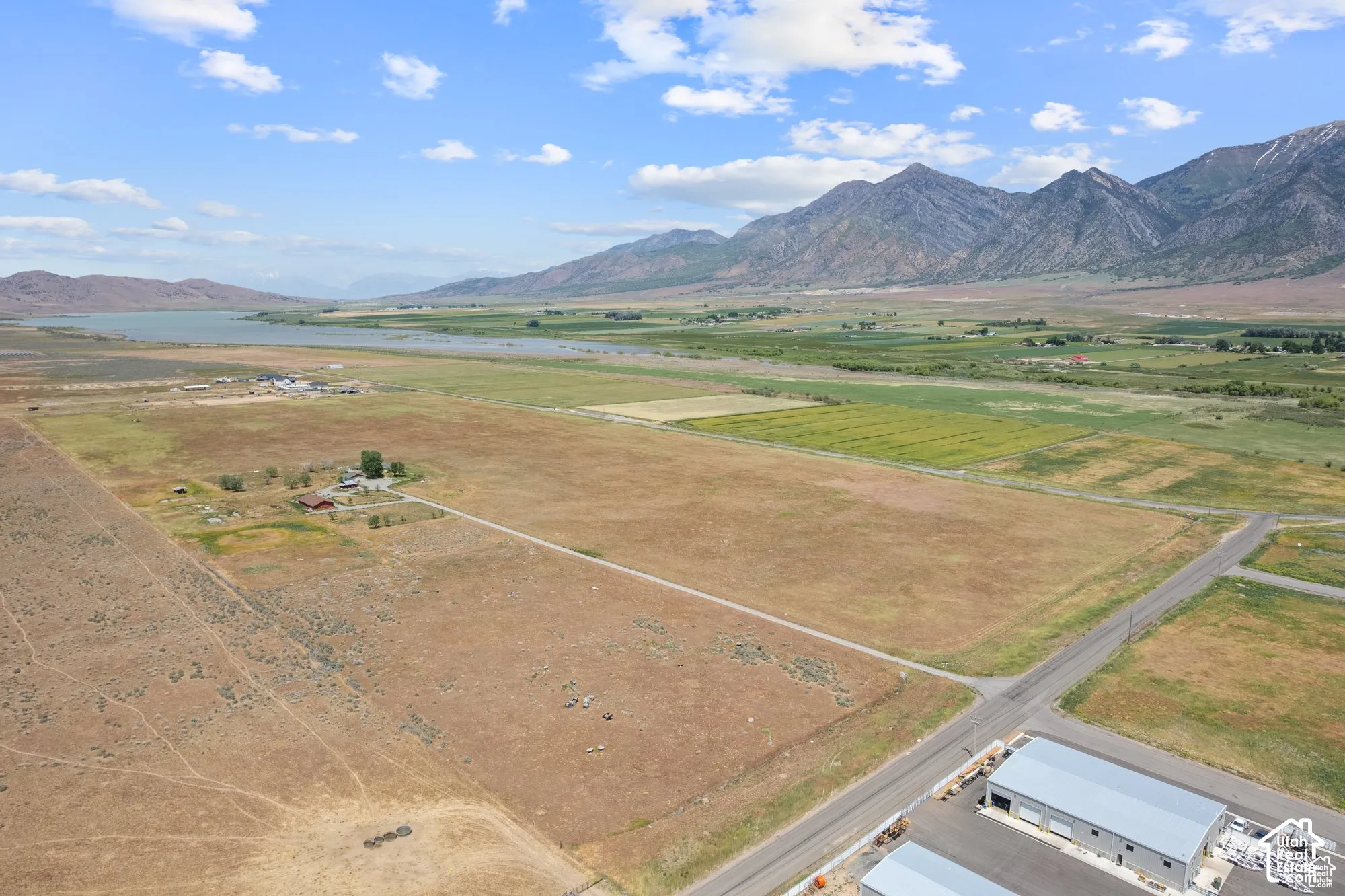 Expansive acreage featuring mountain range topography, proximity to water, and paved road access