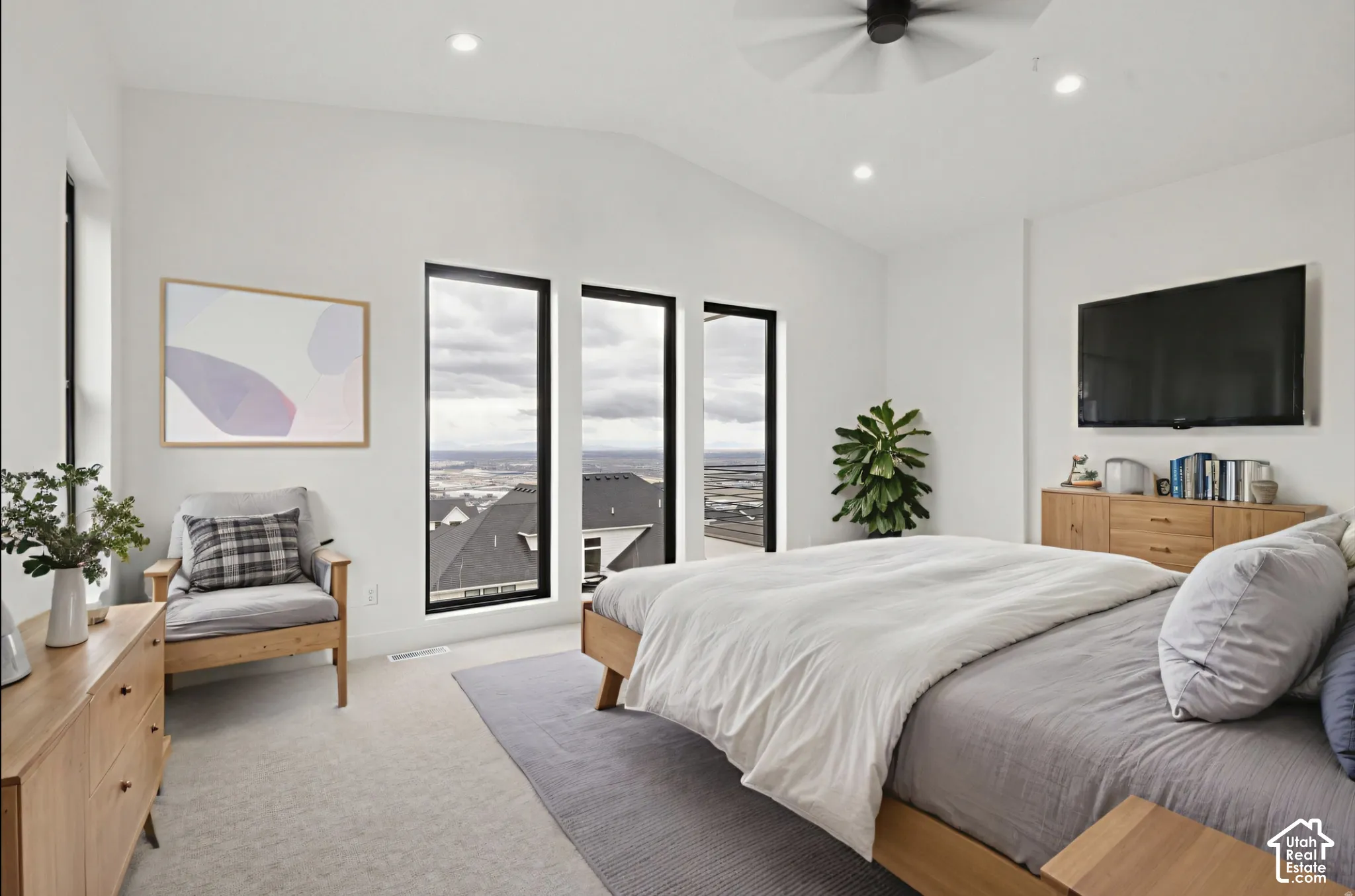Vaulted ceilings, expansive windows with black frames, recessed lighting, and a modern ceiling fan