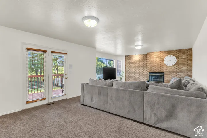 Brick fireplace featuring a built-in firebox, full-height masonry surround, and double glass-paneled doors opening to the exterior