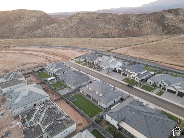 Aerial perspective featuring residential lots with manicured lawns and mountain backdrop