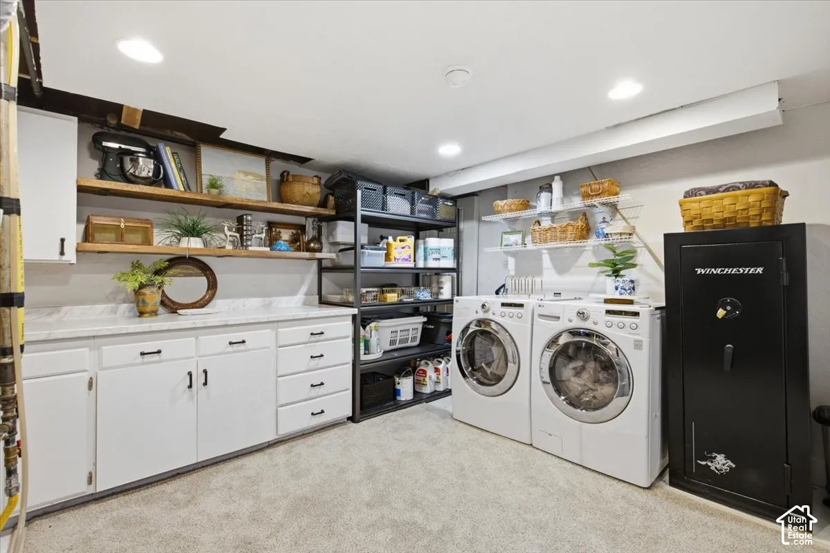 Laundry space featuring white cabinetry with stone-finish countertops, floating wood shelves, recessed lighting, and dedicated space for appliances