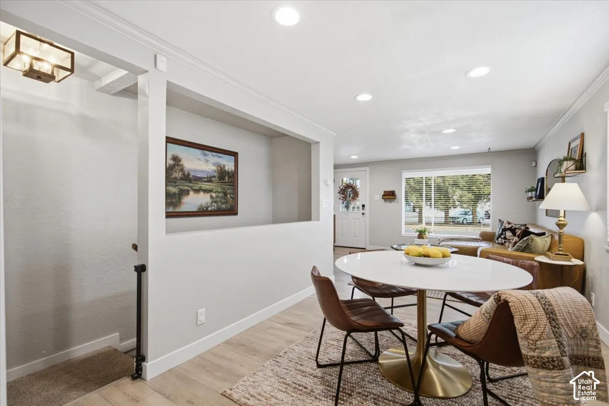 Interior space featuring wood-finish flooring, recessed lighting, crown molding, and a built-in recessed wall niche
