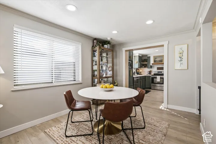 Recessed lighting, wood-finish flooring, and crisp white trim framing the wide threshold