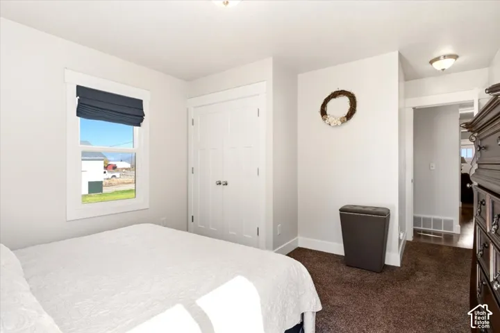 Neutral wall finishes, double-door closet with shaker-style panels, window with crisp white casing, and flush-mount lighting