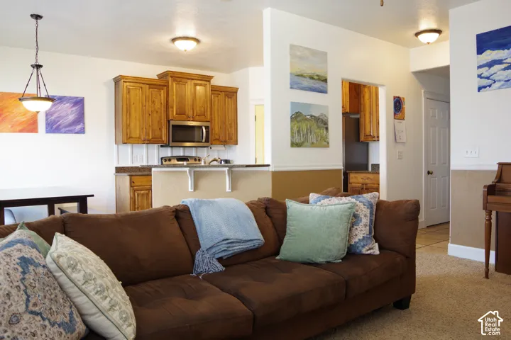 Kitchen featuring stained wood cabinetry, a peninsula countertop, and a built-in microwave