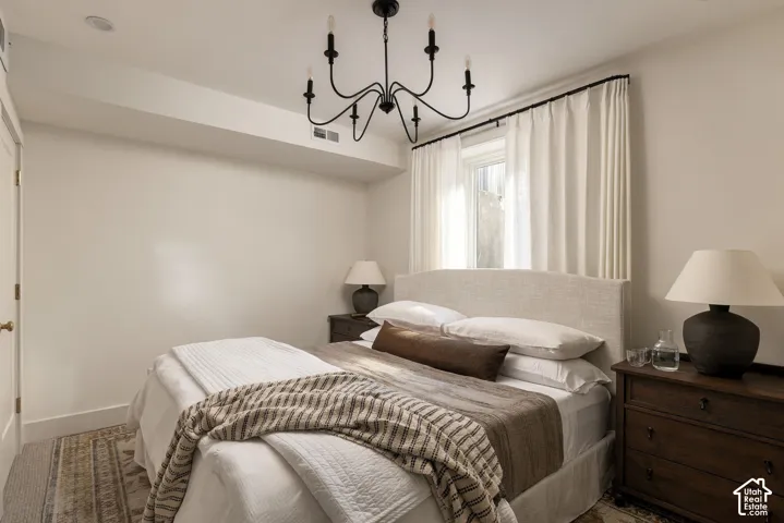 Room featuring neutral-toned walls, recessed lighting, and a black multi-arm chandelier