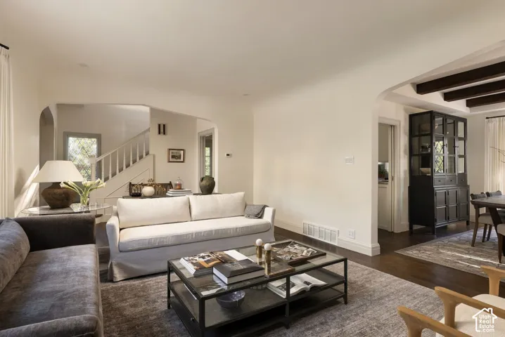 Arched entryways, exposed ceiling beams, and wood-finish flooring