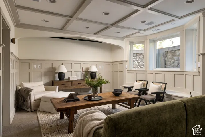 Coffered ceiling with recessed lighting, wainscoting, arched architectural detail, and a bay window featuring a built-in bench seat