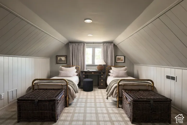 Angled ceiling featuring diagonal plank wall paneling, recessed lighting, and a centered window