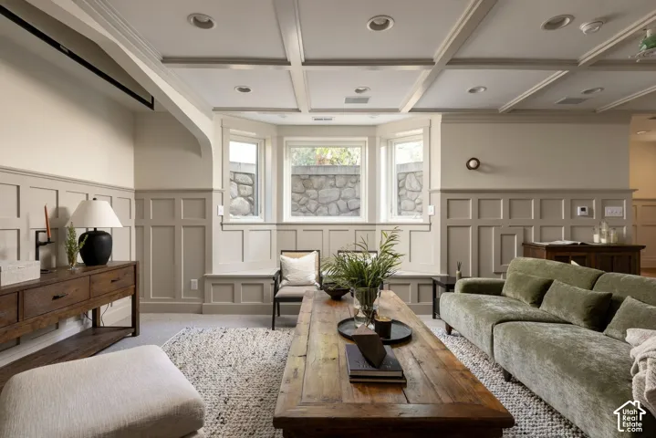 Coffered ceiling, wall paneling, bay window with integrated bench seating, and recessed lighting
