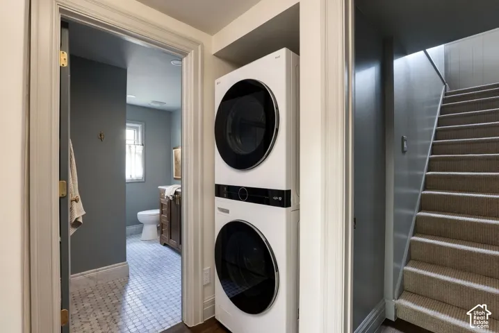 Stacked laundry unit featuring a white finish and black circular glass doors, positioned within a built-in enclosure