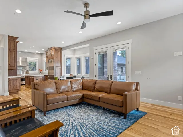 Open-concept interior featuring wood-finish flooring, recessed lighting, and a modern ceiling fan