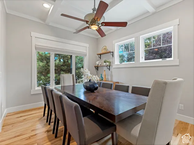 Coffered ceiling with recessed lighting, wood-finish flooring, and expansive windows with wide white trim