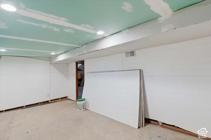 Interior space featuring horizontal white wall paneling and recessed lighting