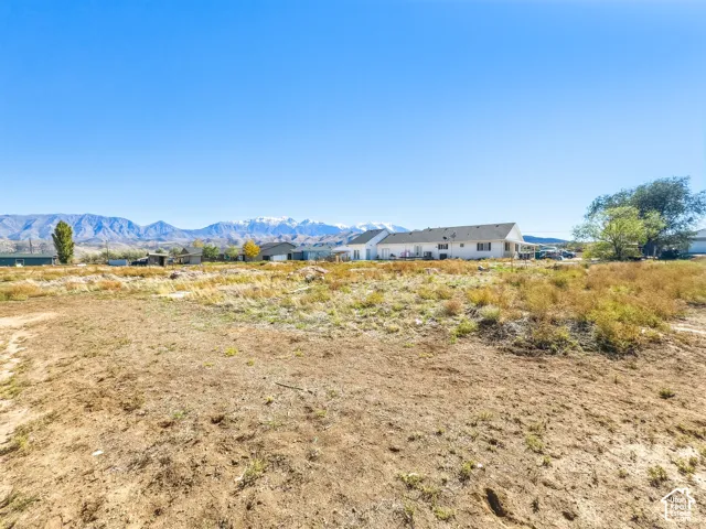 Expansive lot featuring native terrain and prominent mountain range backdrop