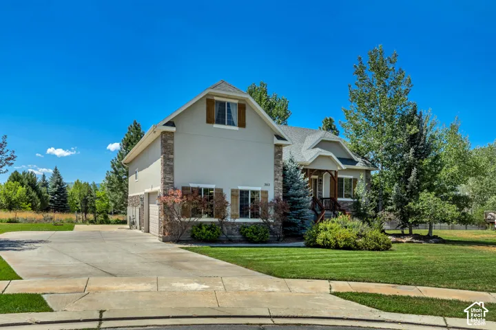 Two-story exterior featuring a stone and stucco fa