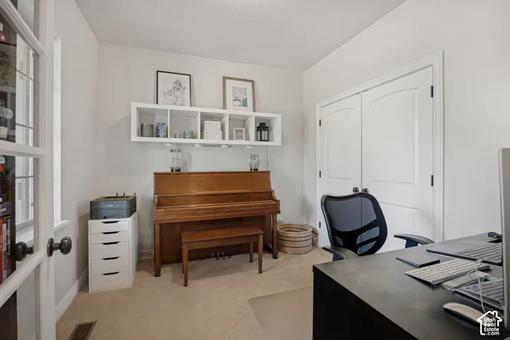 Room featuring white built-in wall shelving, double-panel interior doors, and French-style glass paneled door entry