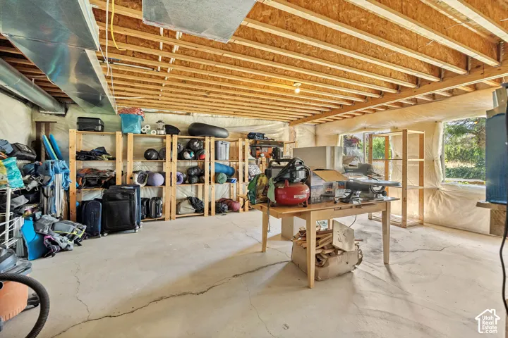 Unfinished basement featuring exposed joists, concrete flooring, exterior-facing window, and spray foam perimeter insulation