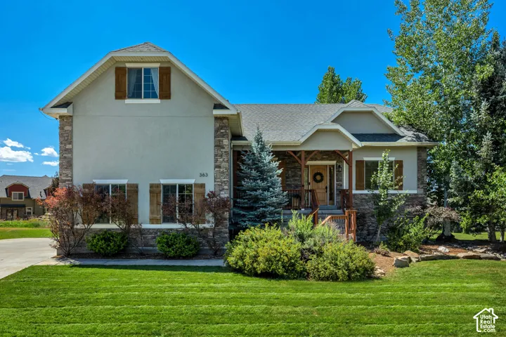 Exterior featuring a stone and stucco facade, timber-framed covered entryway, decorative wooden window shutters, and a multi-gabled roofline