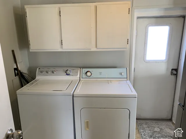 Laundry area featuring built-in wall-mounted cabinetry and an exterior door with an integrated window