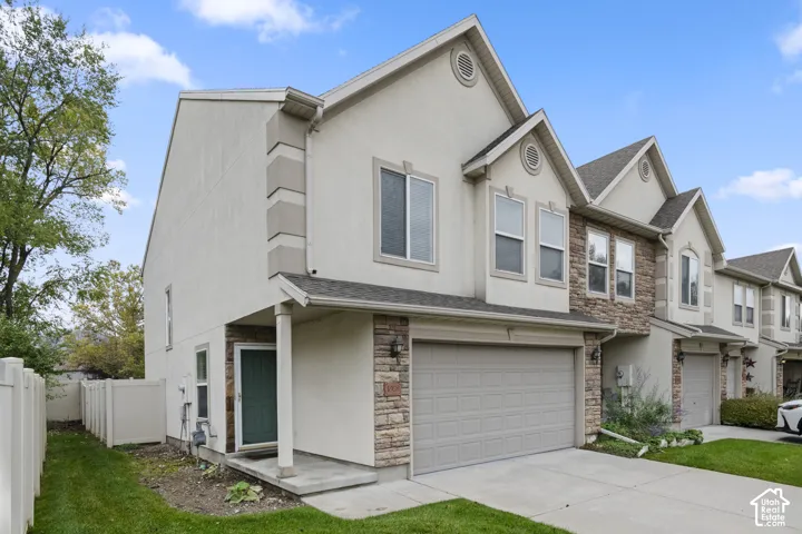 Two-story exterior featuring a stucco and stone veneer fa