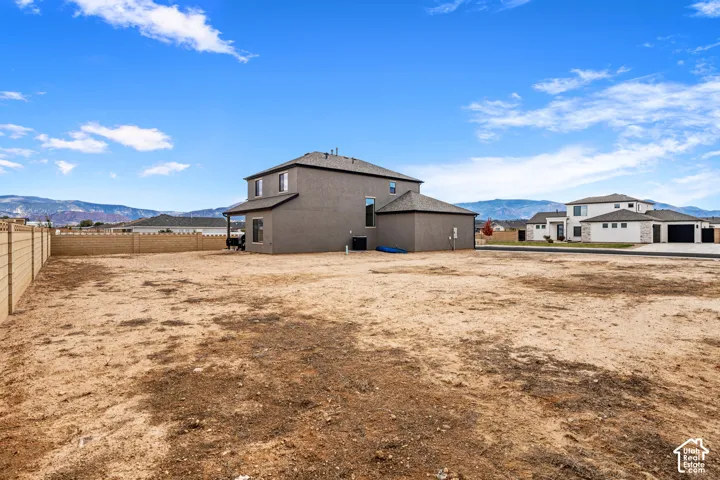 Expansive lot featuring a perimeter masonry wall and mountain backdrop