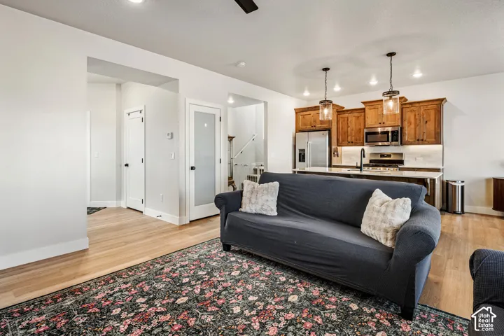 Kitchen featuring wood cabinetry, stainless steel appliances, and a quartz countertop island with dual pendant lighting
