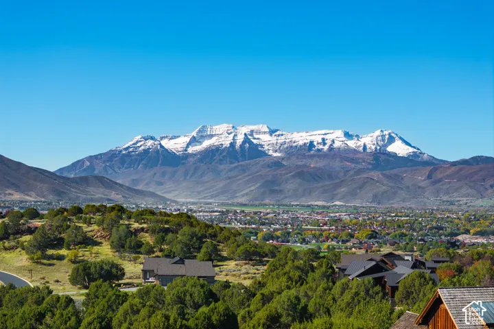 Panoramic mountain range backdrop featuring snow-capped peaks and expansive valley terrain