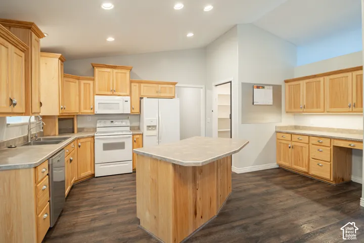 Kitchen featuring light wood cabinetry, center island with additional storage, wood-finish flooring, recessed lighting, and a walk-in pantry