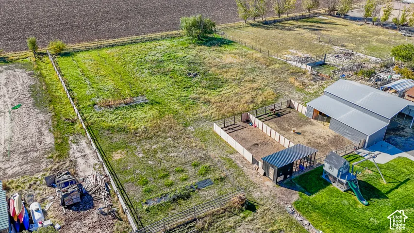 Expansive parcel featuring perimeter fencing, a multi-stall barn, dedicated livestock pens, and an open acreage layout