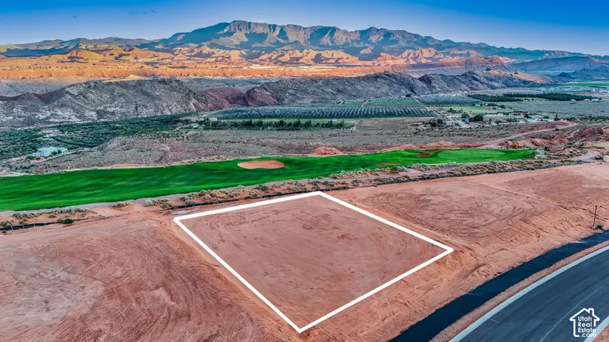 Vacant residential lot featuring an expansive building envelope, road access, and mountain and golf course scenery
