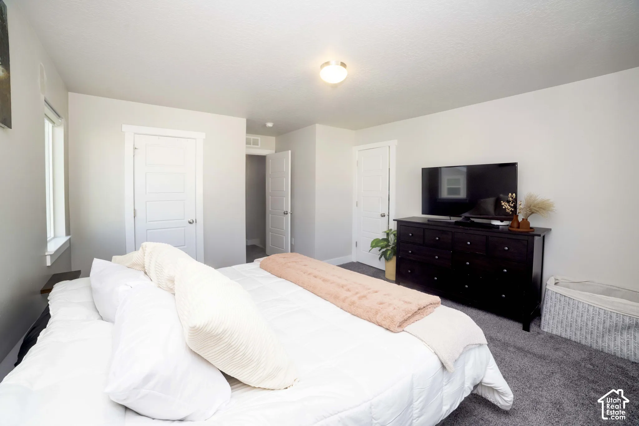 Neutral interior featuring carpeting, five-panel interior doors, recessed ceiling lighting, and a single window with white trim
