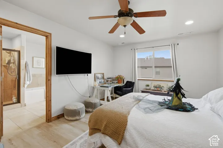 Bedroom featuring wood-finish flooring, a ceiling fan with integrated lighting, and natural light through a single-pane window